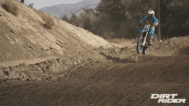a dirt rider riding a dirt bike on a dirt road