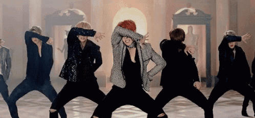 a group of men are dancing in a room .