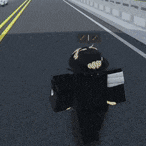 a man in a black hat is walking down a street
