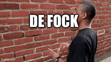 a man is standing in front of a brick wall with the words de fock on it