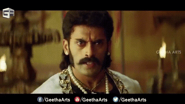 a man with a mustache and a pearl necklace is on a screen that says geetharts