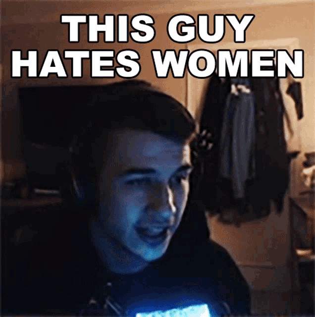 a man in a dark room with the words " this guy hates women " behind him