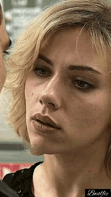 a close up of a woman 's face with the word bwolfie in the bottom right corner