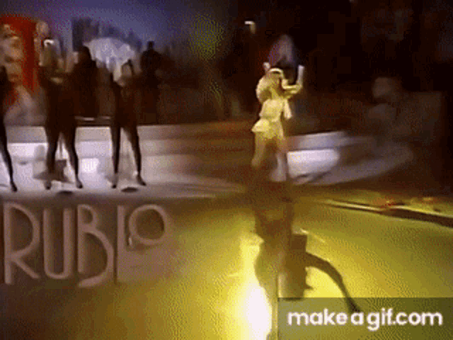 a group of people dancing on a stage with the word rubio in the background