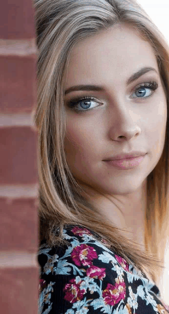 a close up of a woman 's face with blue eyes