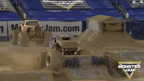 a monster jam truck jumps over a muddy track