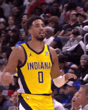 a basketball player wearing a yellow indiana jersey with the number 0 on it