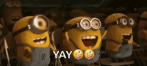 a group of minions are standing next to each other and laughing in a classroom .