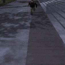 a man standing on a sidewalk wearing a black jacket and green pants