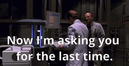 two men in lab coats looking at a computer screen with the words now i 'm asking you for the last time written below them