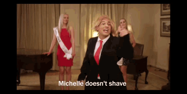 a man in a suit and tie says michelle does n't shave in front of a piano