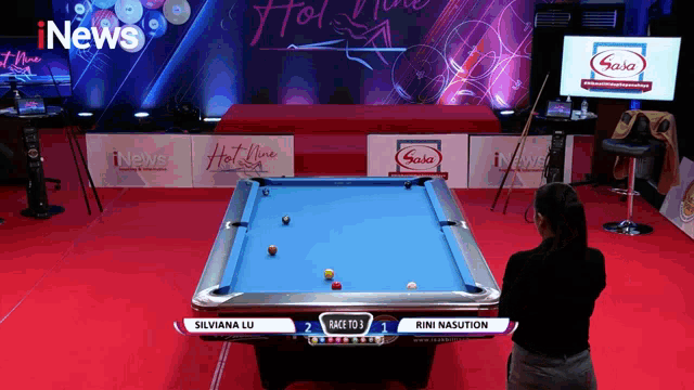 a pool table with a sign that says inews in the background