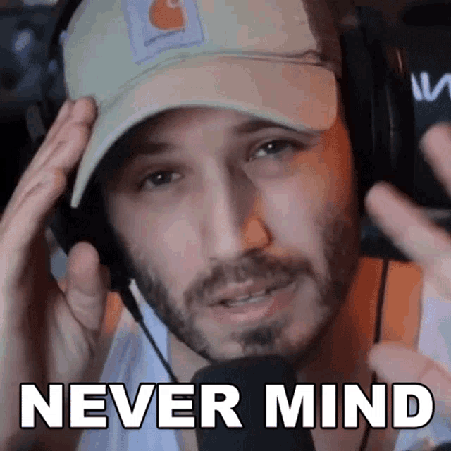 a man wearing headphones and a hat with the words never mind above him