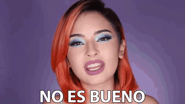 a woman with red hair is making a funny face with the words no es bueno behind her .