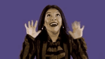 a woman in a striped jacket is making a surprised face