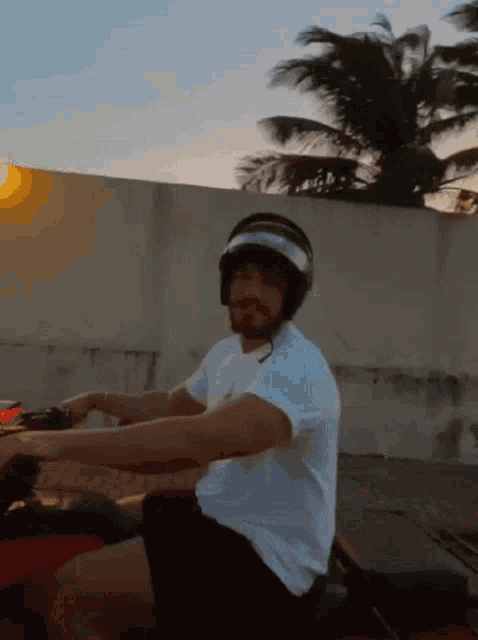 a man wearing a helmet and sunglasses is riding a vehicle