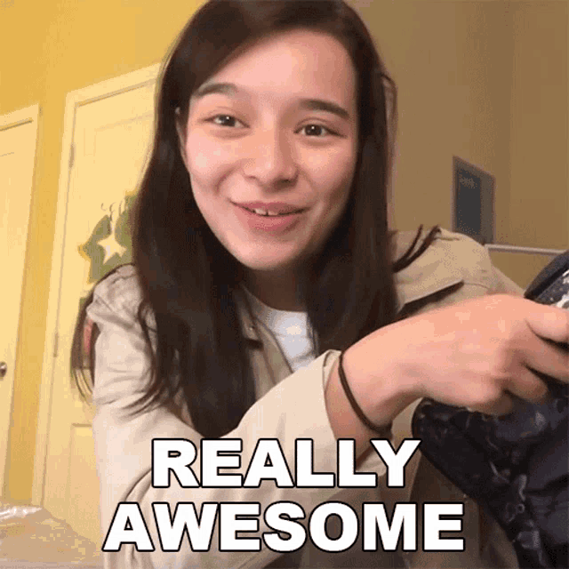a woman is smiling and holding a bag with the words really awesome below her