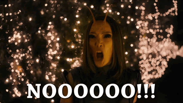 a woman with horns is screaming in front of a blurred background with the words noooooo !!! written on it