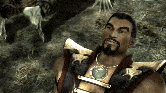 a man with a beard wearing a necklace with a green stone