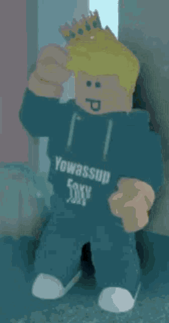 a roblox character with a crown on his head wearing a yowassup shirt