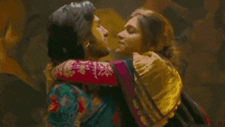 a man and a woman are kissing each other in a dark room .