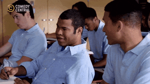 a group of young men are sitting in a classroom with comedy central written on the bottom