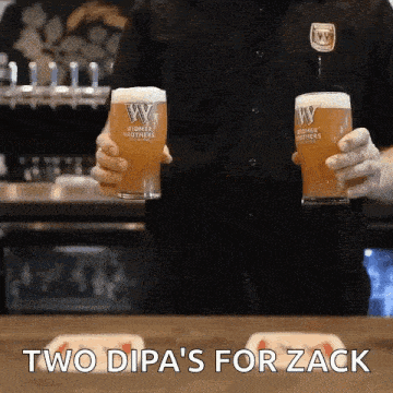 a bartender is holding two glasses of beer with the words " two dipas for zack " on the bottom