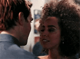 a man and a woman are looking at each other with their eyes closed