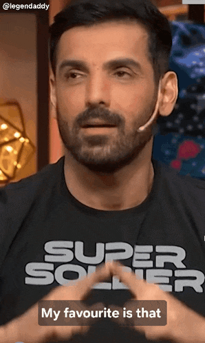 a man with a beard is wearing a super soldier t-shirt
