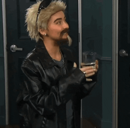 a man with a mustache and a wig is holding a glass of water