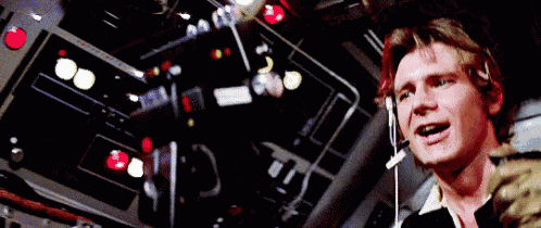 a man wearing a headset is standing in front of a control panel in a room .