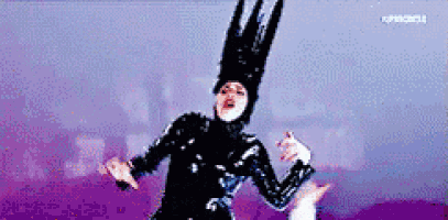 a pixelated image of a person wearing a black costume and a large hat