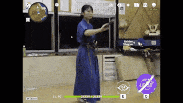 a woman in a blue kimono is holding a sword in a video game