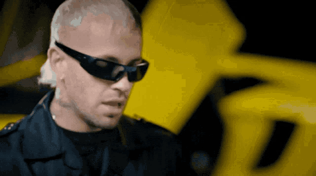 a man wearing sunglasses and a black jacket