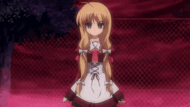 a girl with blonde hair and a red tie stands in front of a red fence