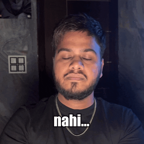 a man with his eyes closed has the word nahi on his chest