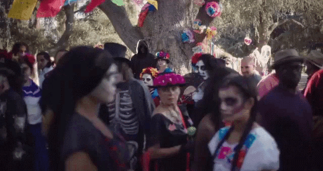 a group of people dressed in day of the dead costume