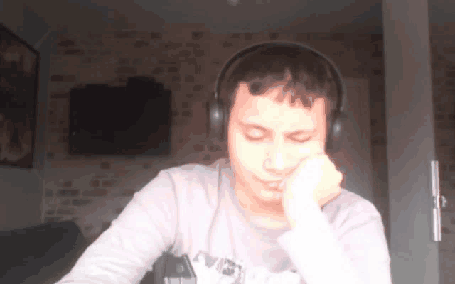 a man wearing headphones and a shirt that says ' avengers ' on it