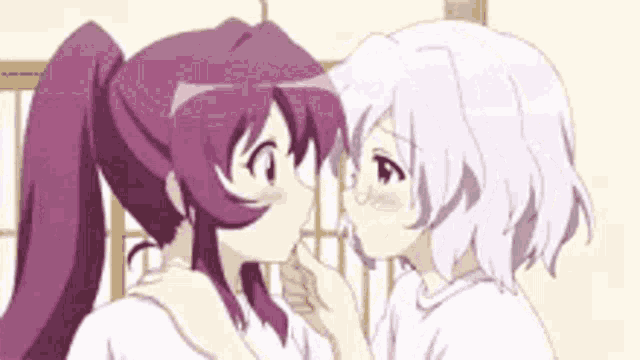 two anime girls are kissing each other .