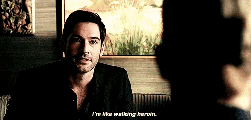 a man in a suit is talking to a woman in a dark room and says i 'm like walking heroin .