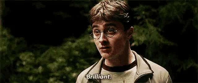 a close up of a man with glasses and the words brilliant on his face