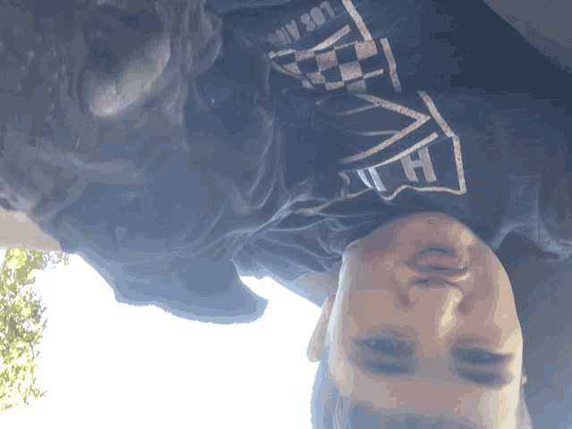 a man wearing a shirt that says vans on it