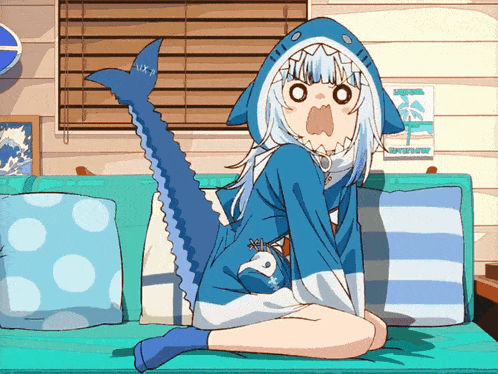 a girl in a shark costume sits on a blue couch