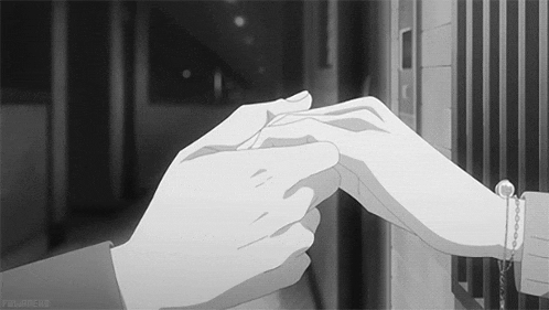 a black and white photo of a person holding another person 's finger