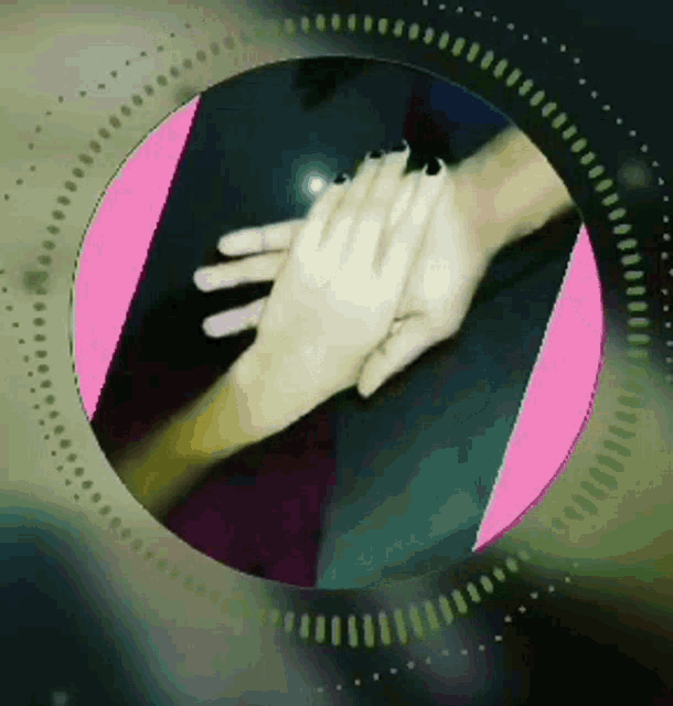 a couple of hands are holding each other in a pink and black circle