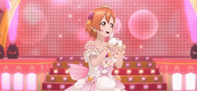 a girl in a white dress is standing on a stage with a pink background .