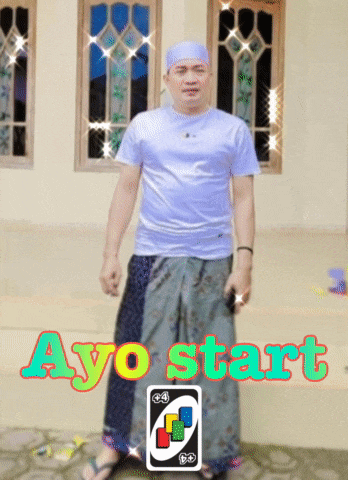 a man standing in front of a building with ayo start written on the top