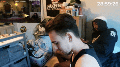 a man sitting in front of a sign that says ' exxxnn 's league ' on it