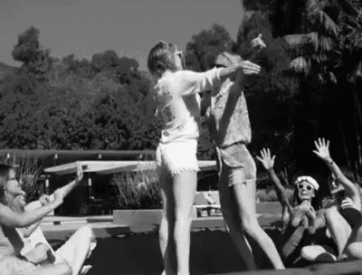a group of people are dancing on a trampoline .