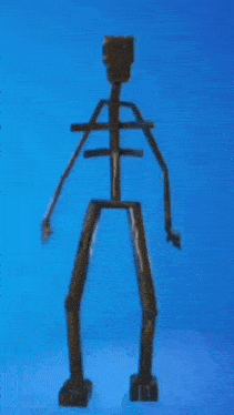 a statue of a skeleton is against a blue background .